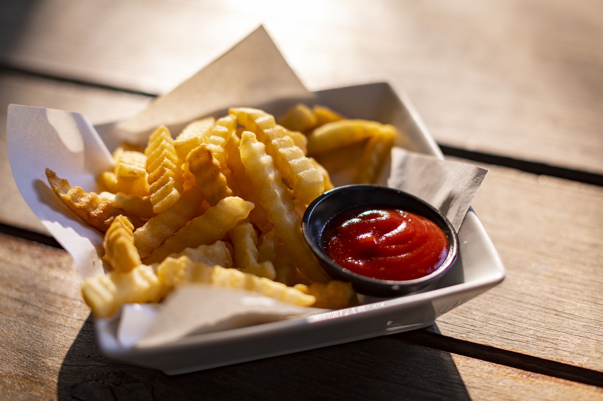 tasty french fries on wooden table