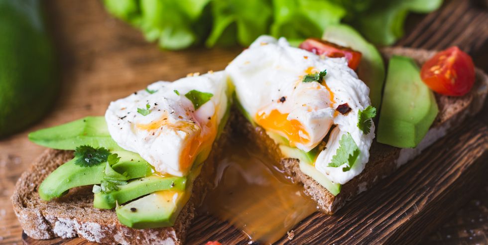 tasty sandwich with poached egg and avocado