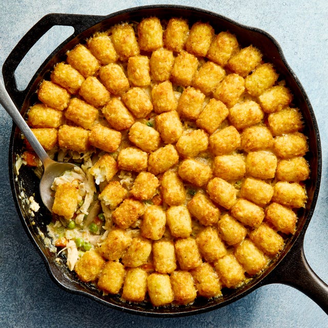 Tater Tot Chicken Pot Pie chicken pot pie filling in a skillet topped with tater tots