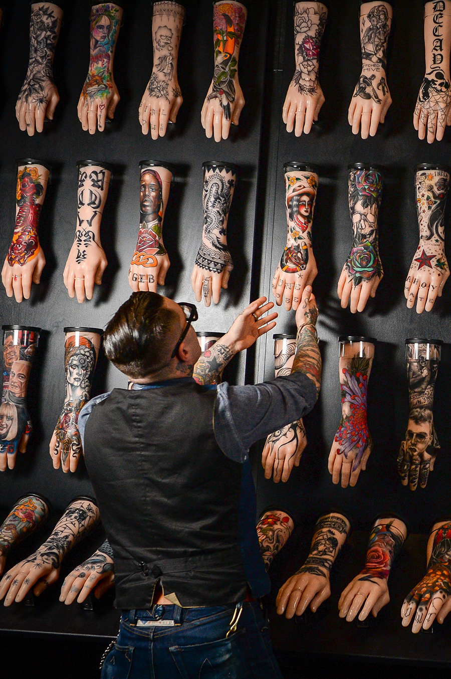 exhibition curator, dr matt lodder, puts the finishing touches to the one hundred silicone arms on display at the national maritime museum in falmouth, cornwall, part of the exhibition tattoo british tattoo art revealed photo by ben birchallpa images via getty images