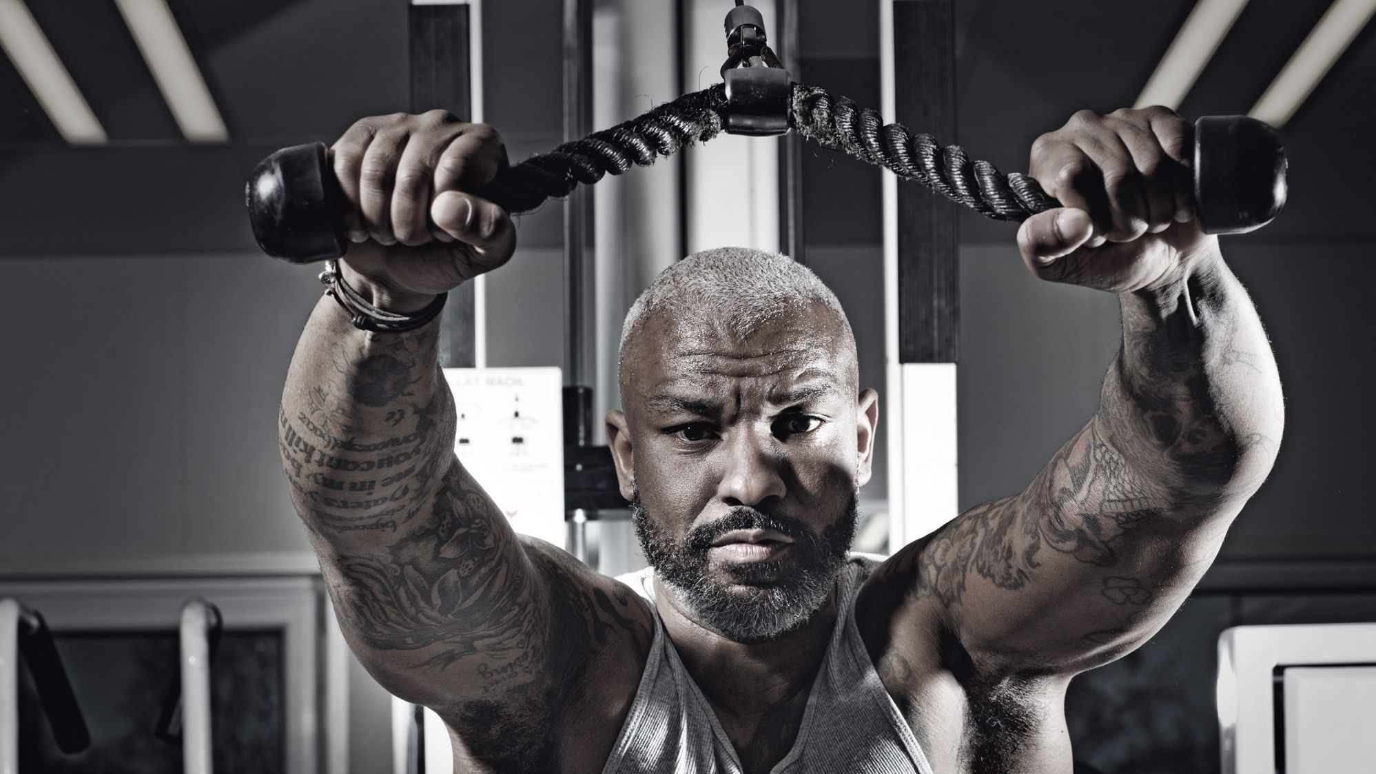 https://hips.hearstapps.com/hmg-prod/images/tattooed-middle-aged-bearded-black-man-at-a-gym-royalty-free-image-1597421419.jpg?crop=1xw:0.74751xh;center,top