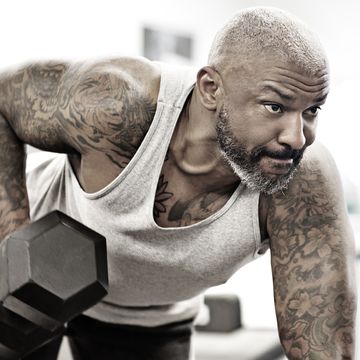 Tattooed middle aged bearded black man at a gym