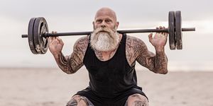 tattooed senior man during workout