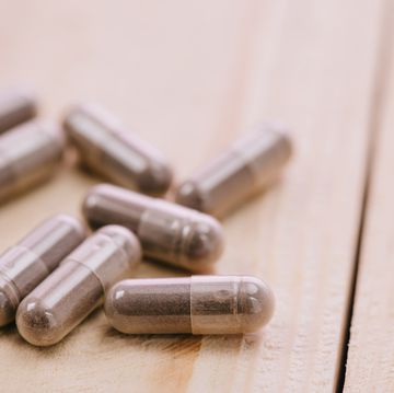 selective focus of scattered pills on wooden table with copy space