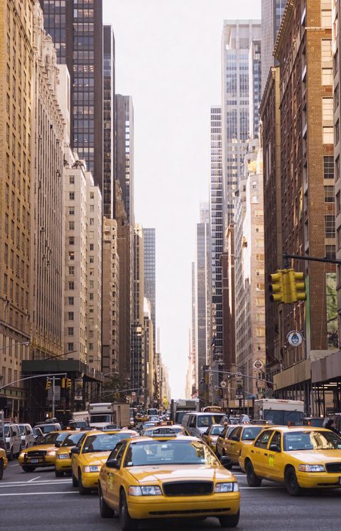 Taxis driving on city street, New York City, New York, United States