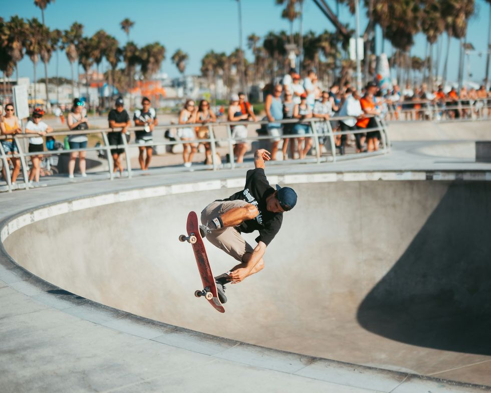 a man riding a skateboard at a skatepark