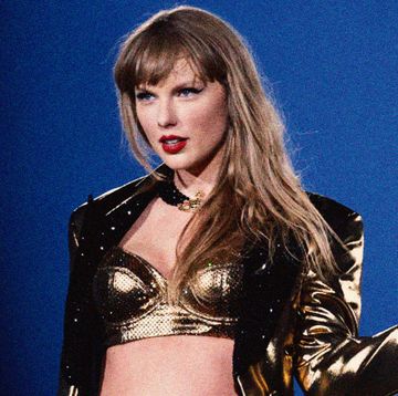 taylor swift on stage in a gold bra and jacket