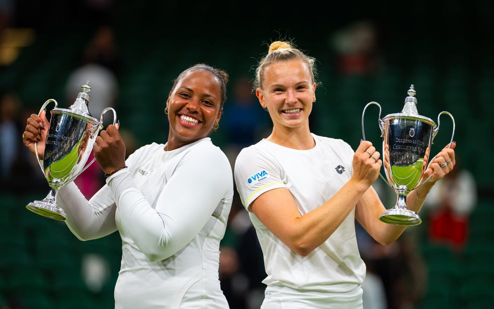 Taylor Townsend of the USA and Katerina Siniakova of the Czech Republic pose with their championship trophies after the doubles final of the Grand Slam tennis tournament Wimbledon Championships 2024