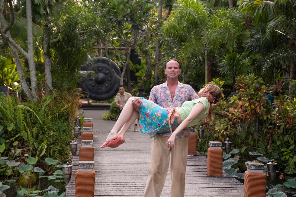 Couple posing in a lush outdoor setting
