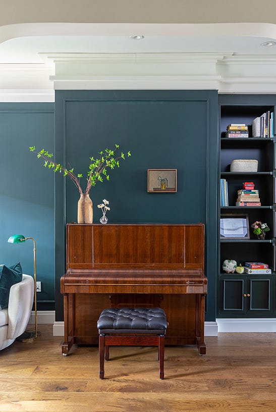 Interior space featuring a stacked bookshelf piano and seating area interior space featuring a stacked bookshelf piano and seating area