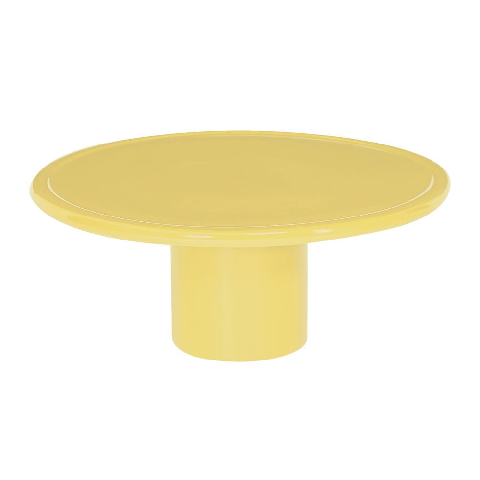 yellow round coffee table on pedestal leg