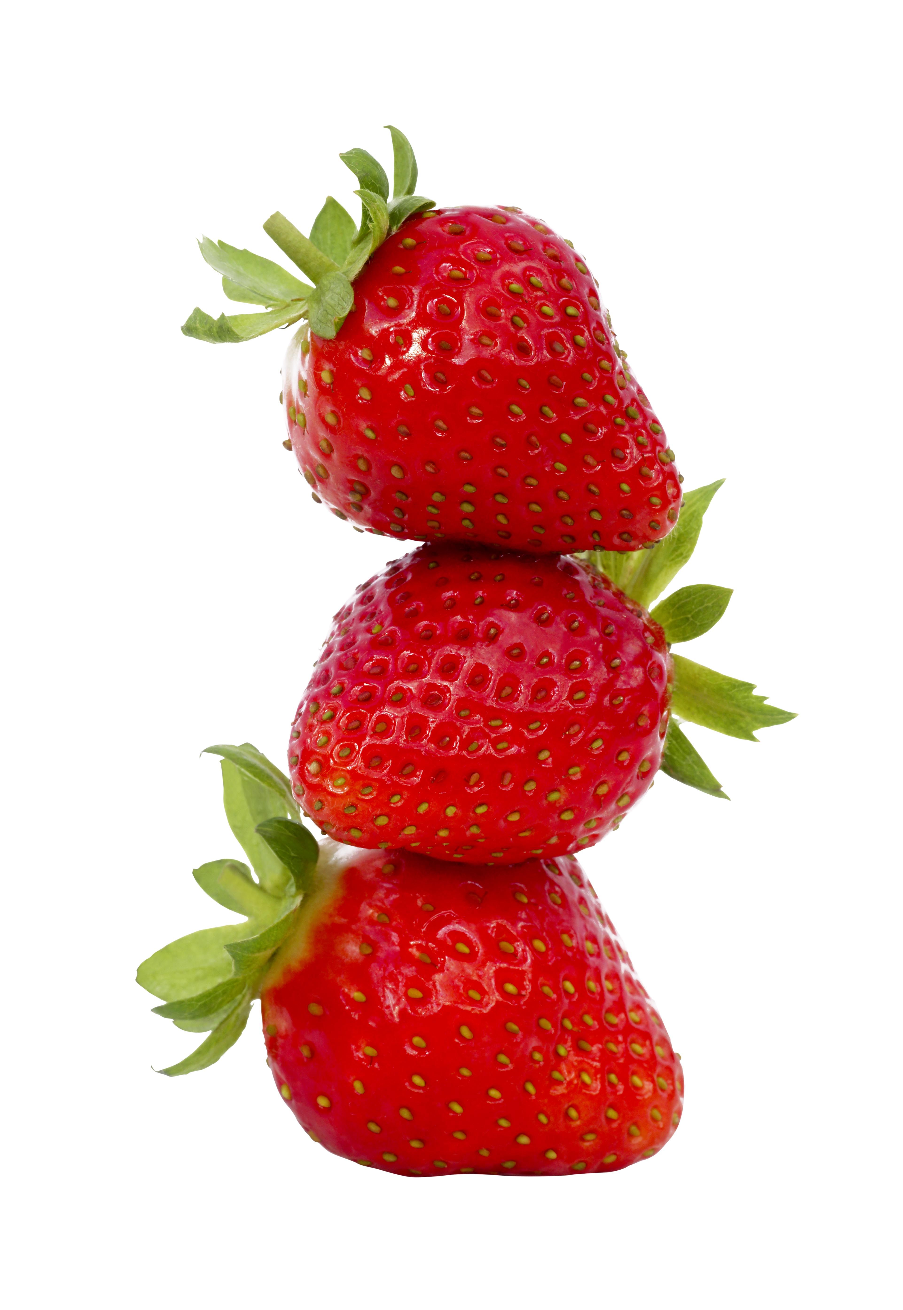 Three strawberries in a stack, on white background