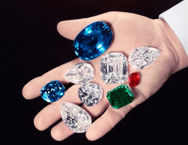 new york, united states 1949 palm of jeweler harry winston displaying some of the gems in his collection including the sapphire of catherine the great next to thumb, the hope diamond between index middle the royal spanish emerald green, the idols eye to l of emerald the j photo by bernard hoffmantime life picturesgetty images