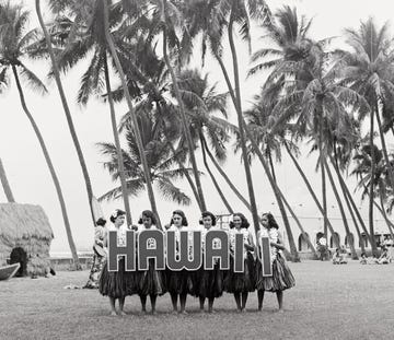 hula dancers on honolulus waikiki beach, form the word hawaii with large letters, to provide a title for those tourists who are about to film the show photo by orlandogetty images