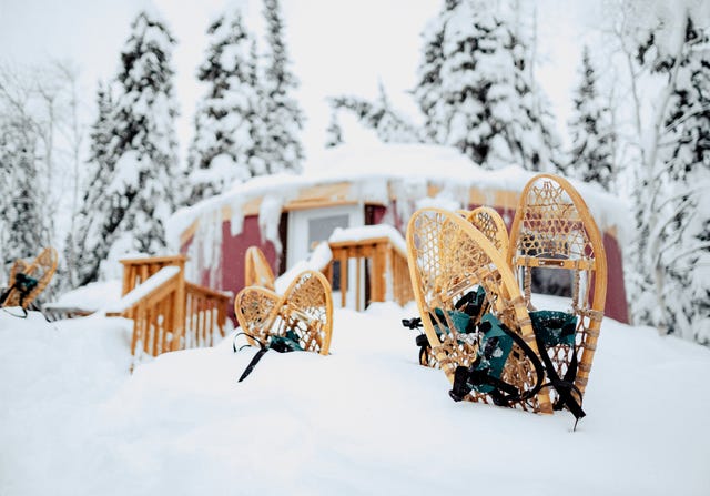 cabin in the yukon with snowshoes