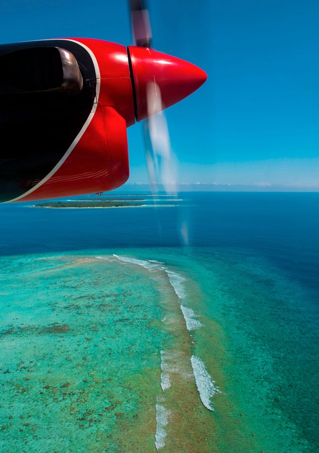d1w3yt maldivian air taxi seaplane flying over an atoll, male, maldives