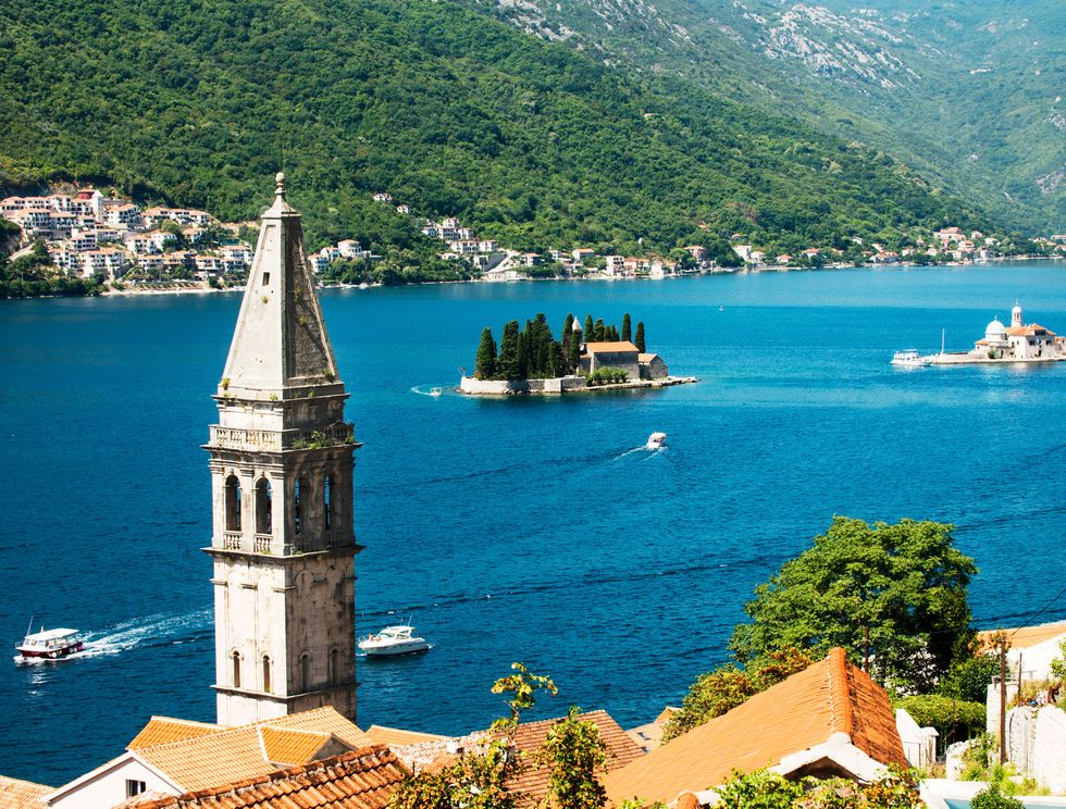 kotor bay in montenegro, the village of perast and the bell tower of the church of saint nicholas the two islands are saint george and our lady of the rocks with the roman catholic church of the same name