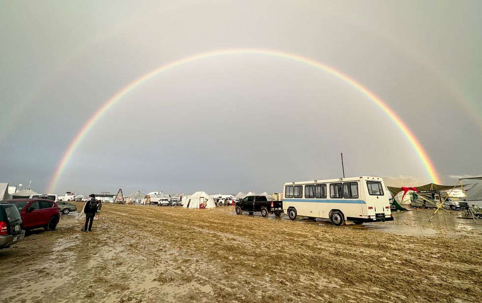 mandatory credit photo by diana jensenepa efeshutterstock 14080086a a person walks in the mud under a rainbow at the burning man festival in the black rock desert, nevada, usa, 02 september 2023 issued 03 september 2023 heavy rains in the normal dry location created deep, heavy mud conditions that made much of the area impassible and forced burning man organizers to close the entrance to the festival burning man festival 2023, black rock city, usa 02 sep 2023