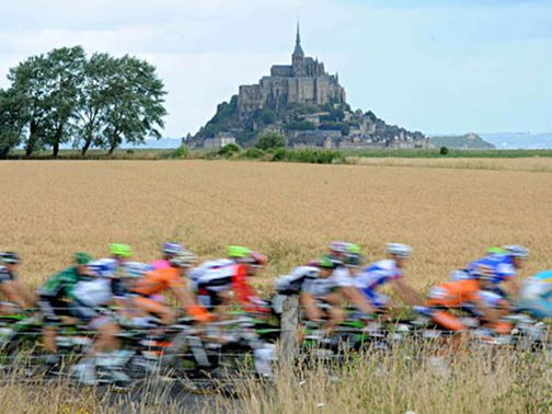 Tour de France cyclists pass Mont Saint Michel