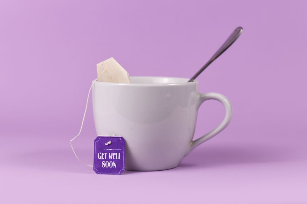 tea bag with made up label with text 'get well soon' in tea cup