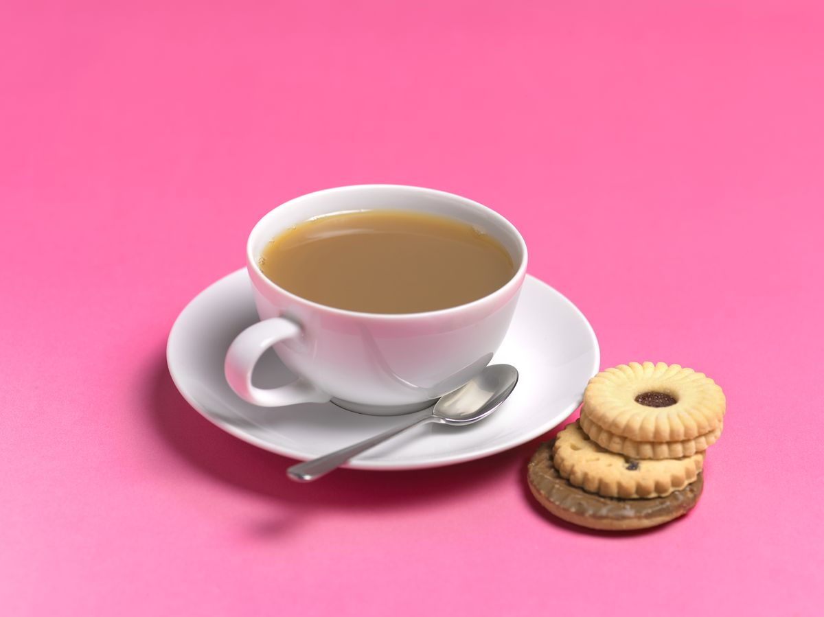 tea cup and cookies on pink background