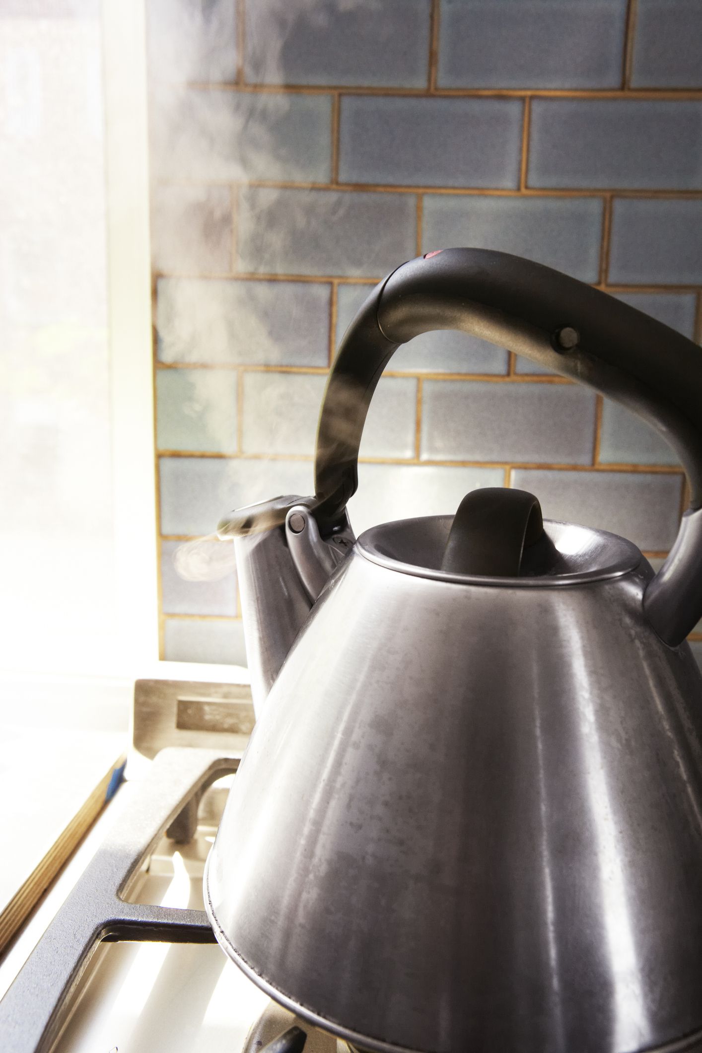 https://hips.hearstapps.com/hmg-prod/images/tea-kettle-blowing-steam-on-a-stove-royalty-free-image-1578939375.jpg