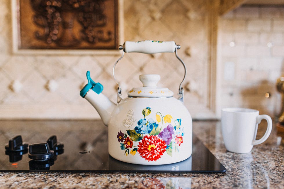 tea kettle on stove top with teacup on the side
