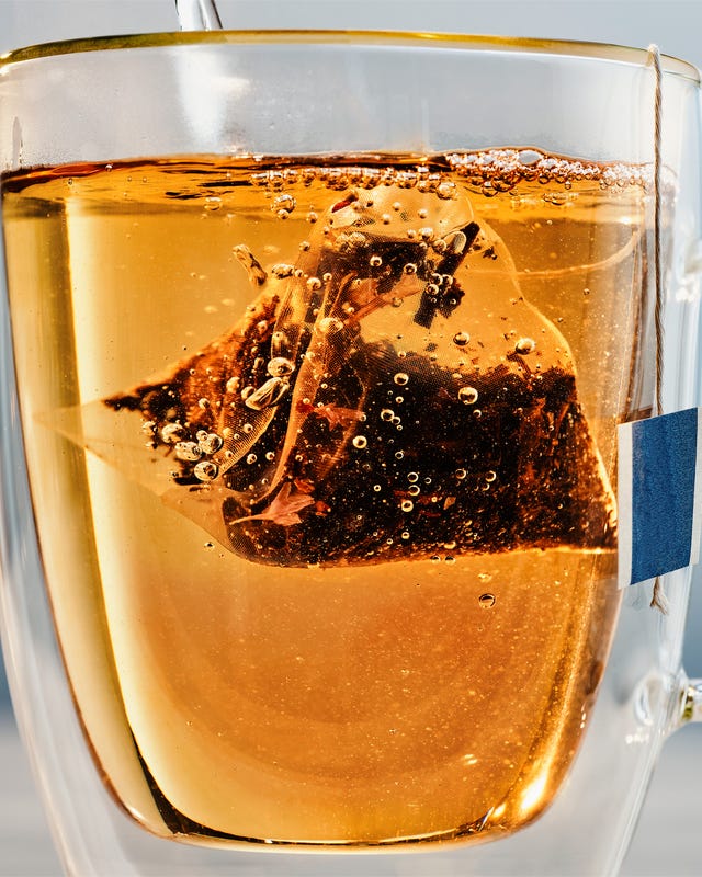 glass of brewed tea with a tea bag submerged