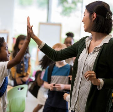 elementary school teacher high fives student