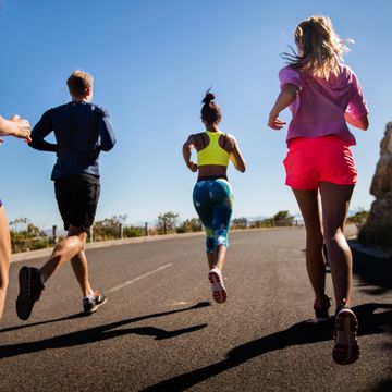 team of athletes running outdoors on summer