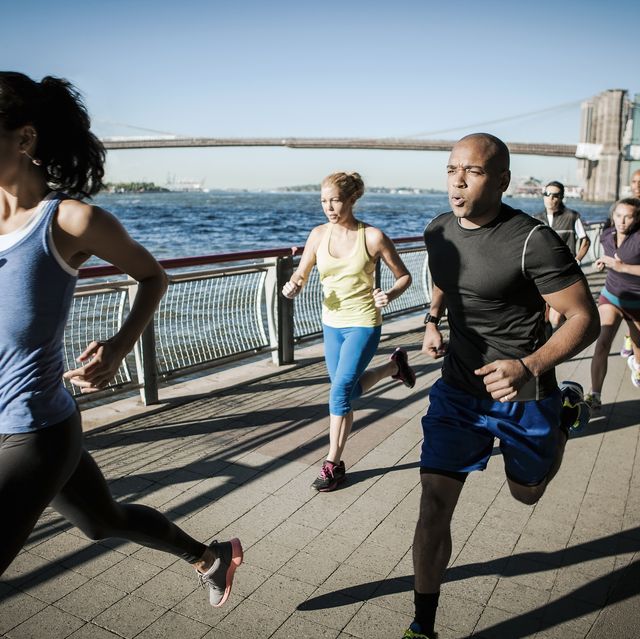 team ankle running together on waterfront, new york, usa
