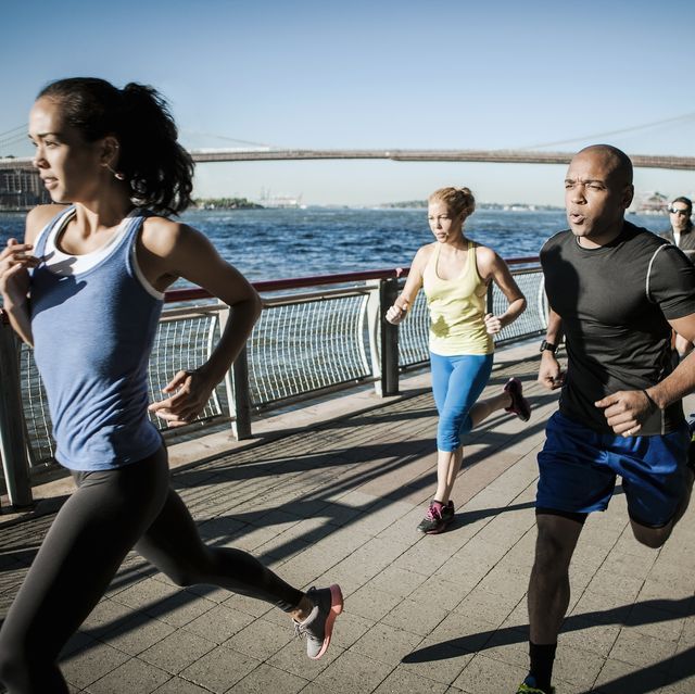 team running together on waterfront, new york, usa