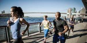 team running together on waterfront, new york, usa