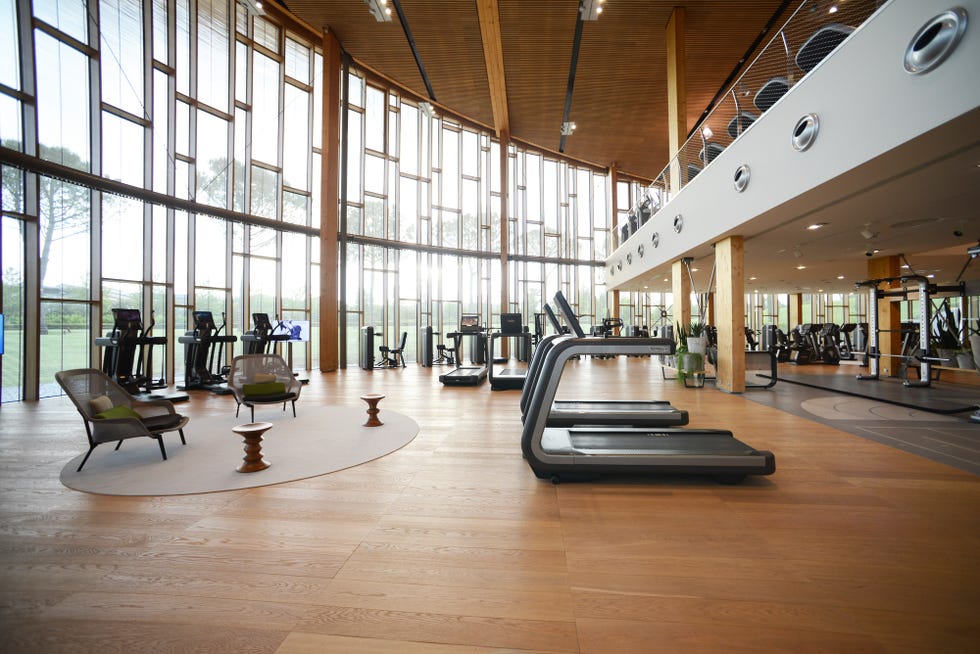 a large room with a large glass wall and a large wooden floor