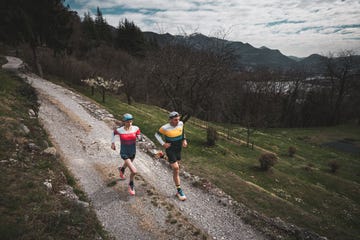 two runners on a gravel path in a natural outdoor setting