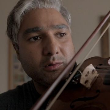 nick mohammed, as nate, plays the violin in a scene from ted lasso season 3 episode 10