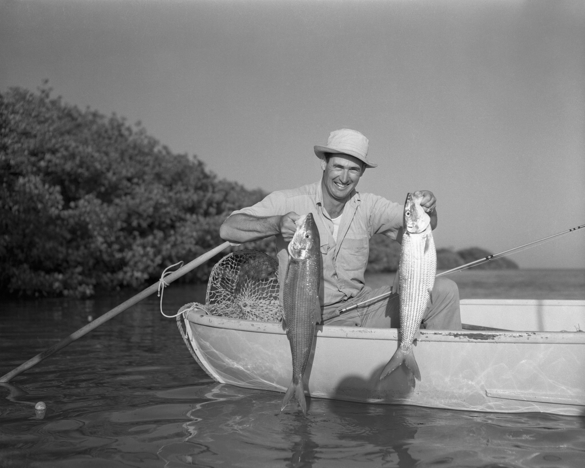 ted williams holding fish in boat