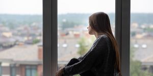 teen abuse,teenager has depression,a young girl is unhappy,upset, looks out the window