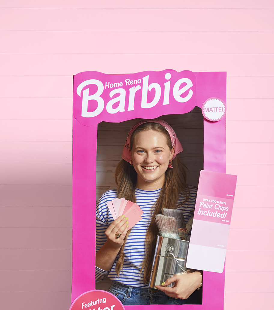 a barbie halloween costume where a girl is dressed as home reno barbie with her head and upper body in a barbie themed pink box