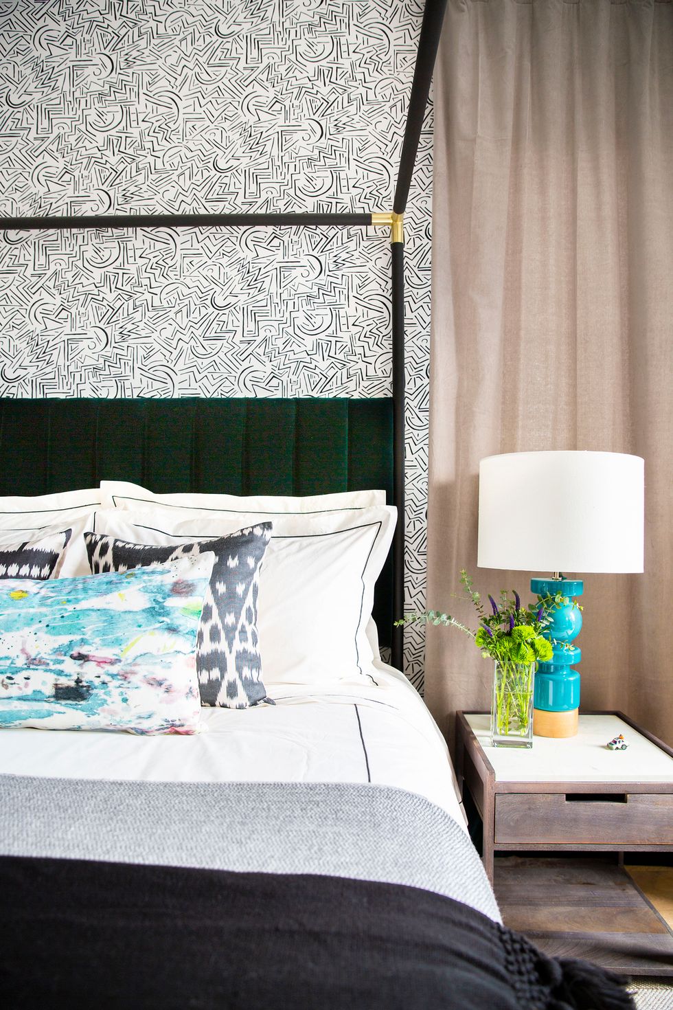 teen bedroom with graphic wallpaper and blue accents