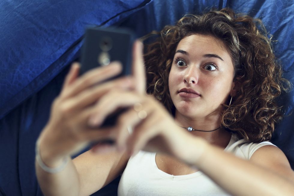 teenage girl and everyday life in bed with smartphone