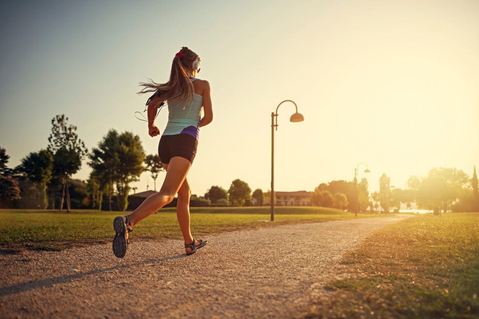 Teenage girl jogging in city park