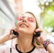 teenage girl outdoors, wearing headphones, listening to music