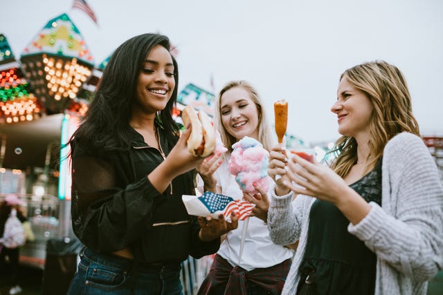 teenage women friend group enjoying state fair food