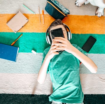 teenager boy with smartphone at home top view