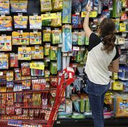 teenager shopping for school supplies in a supermarket