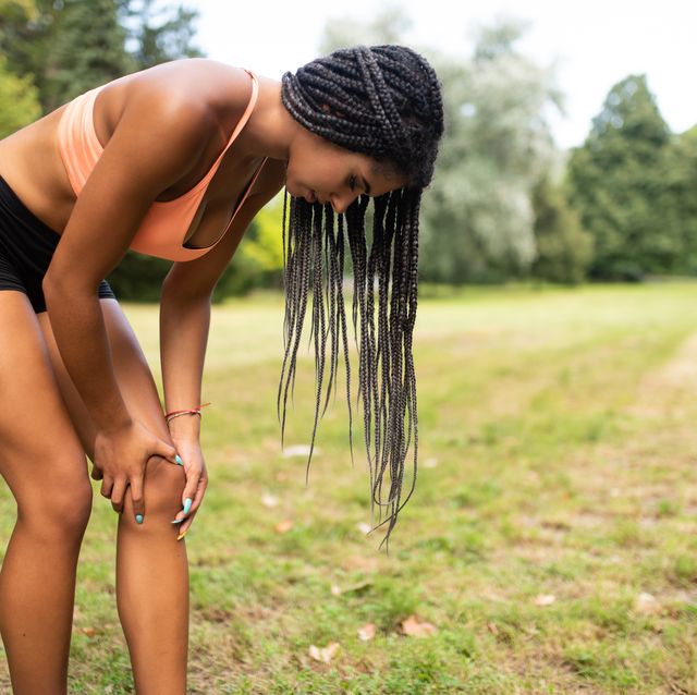 teenager suffering from sports injury in her knee joint