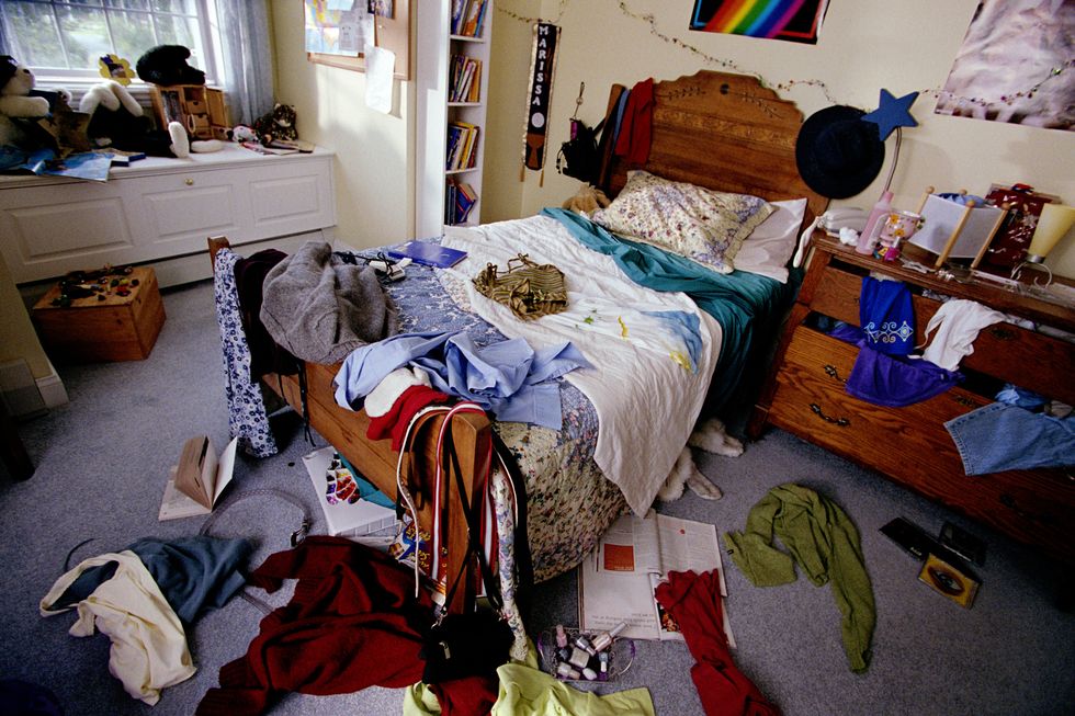 teenager's bedroom with clothes, books and cds thrown around
