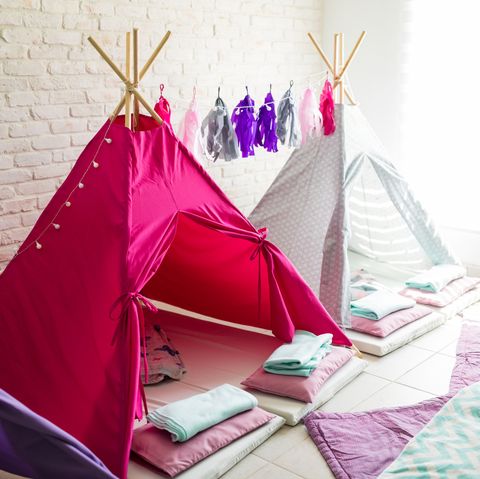 two teepee style tents are set up in a family room