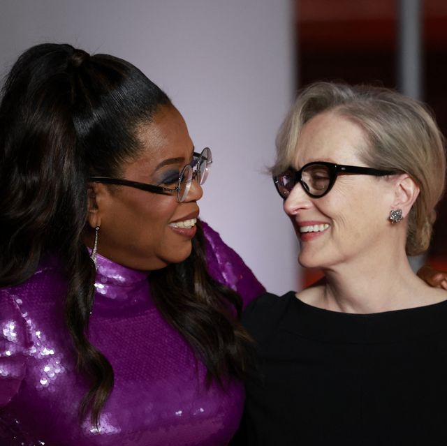 Meryl Streep and Oprah Winfrey smile and hug on the red carpet